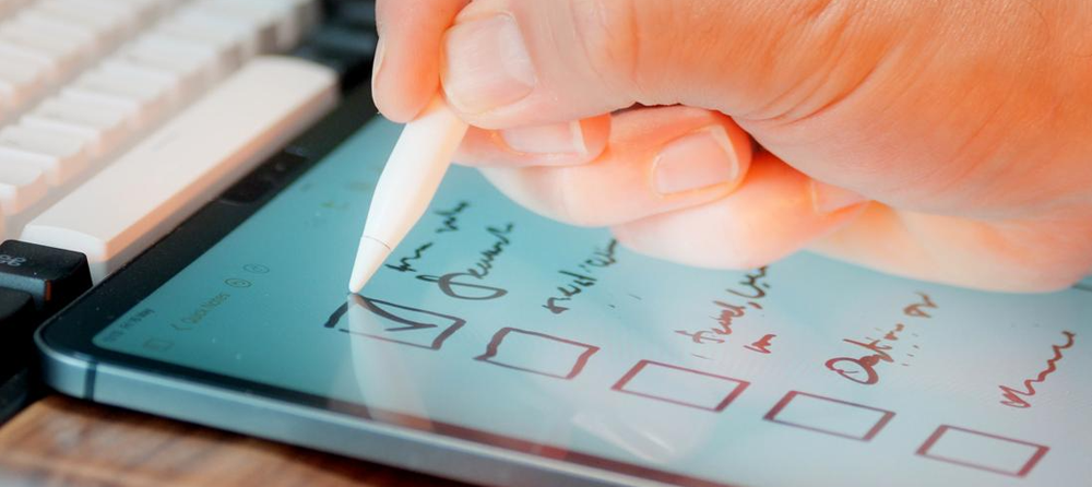 Imagem de uma pessoa marcando um checklst em um tablet