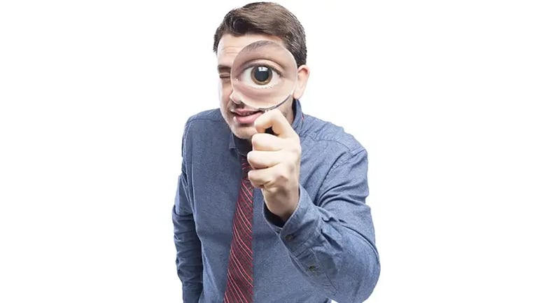A MAN HOLDING A MAGNIFYING GLASS REPRESENTING CERTAIN ENTITIES THAT ARE EXEMPT FROM CTA. 