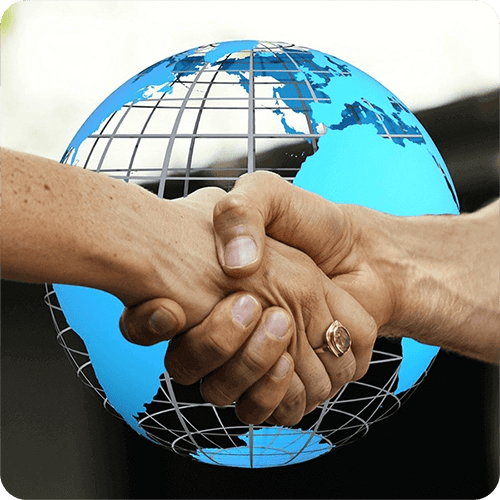 Globe with hands shaking representing cross-border tax services