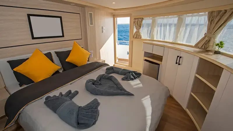 Master bedroom with a double bed inside a luxury yacht.