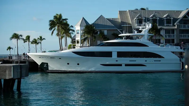 Large white yacht moored at a port in Miami Beach.